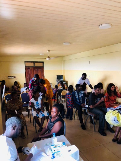 Community members seated during a PAHAM health screening outreach